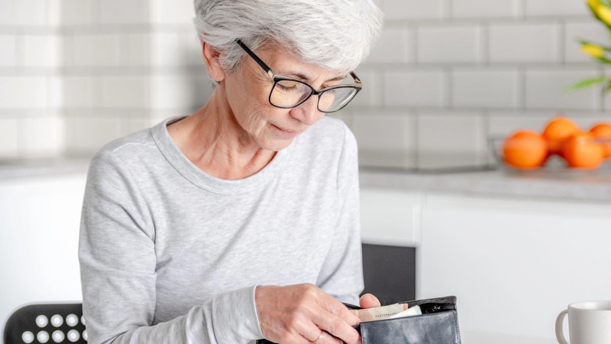 15 Smart Ways Retirees Cut Costs Quietly senior lady checking wallet
