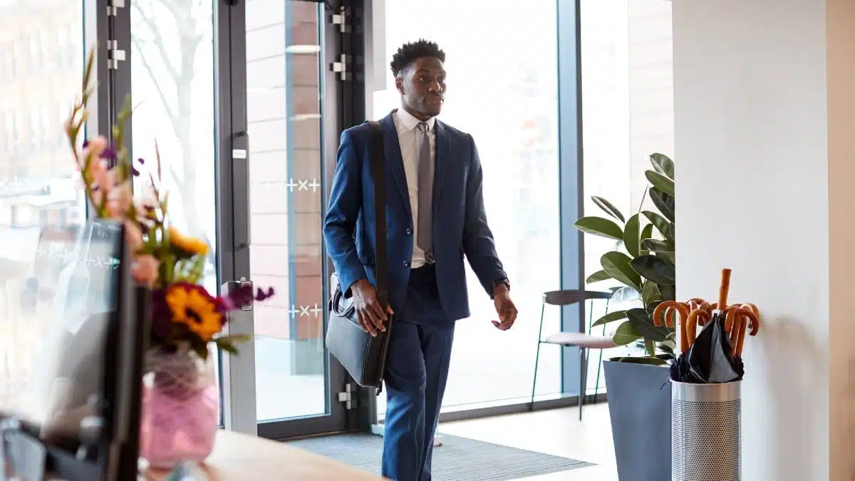 Businessman-Arriving-For-Work-At-Office-Walking-Through-Door-2