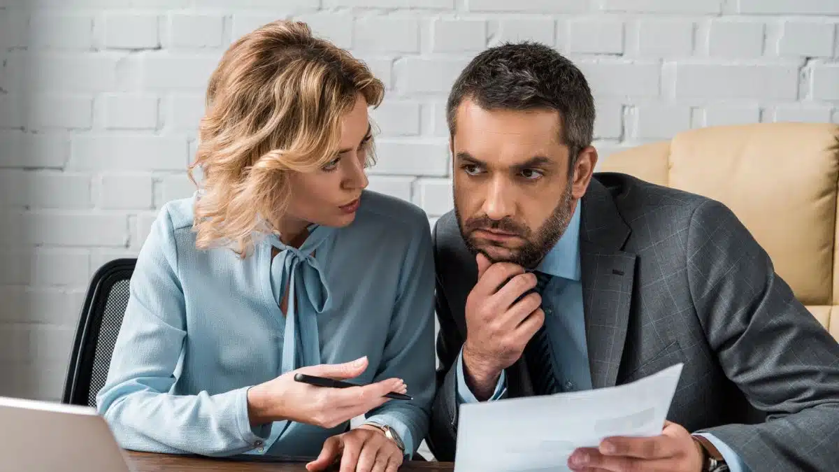 woman talking to coworker man office